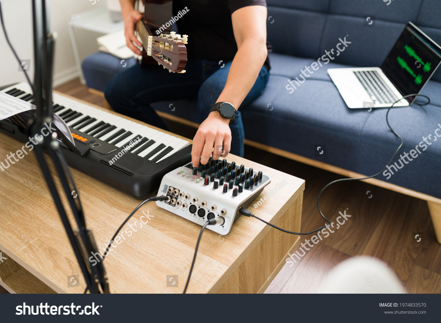 stock-photo-close-up-of-a-young-musician-mixing-his-song-with-a-sound-mixer-to-record-new-music-with-an-1974833570