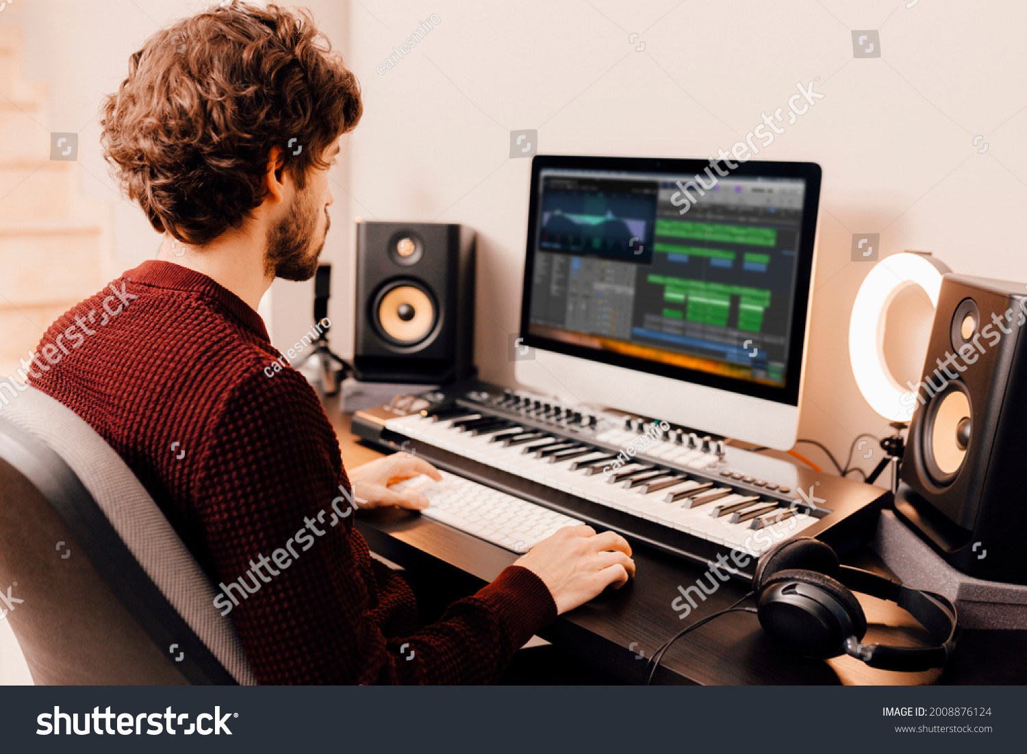 stock-photo-professional-male-music-producer-composer-working-in-recording-home-studio-music-production-2008876124